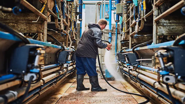 A professional using a pressure hose to clean an industrial area in Danville, VA
