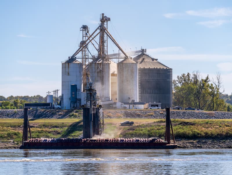 Grain being loaded into freight barges on lower Mississippi river