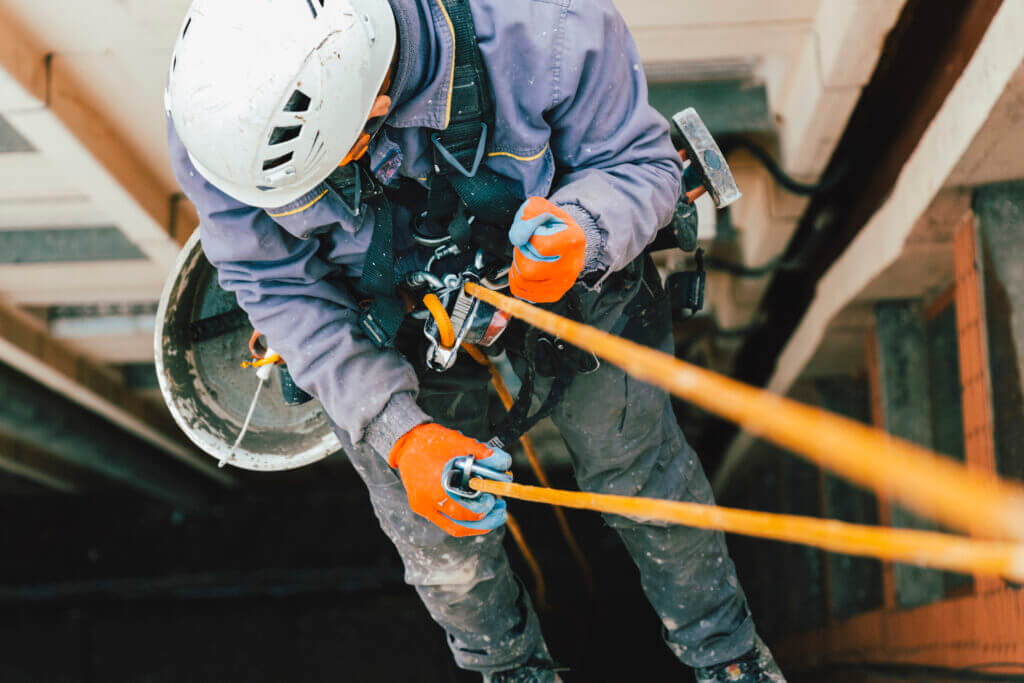Worker using rope safety gear on building exterior in Danville, VA