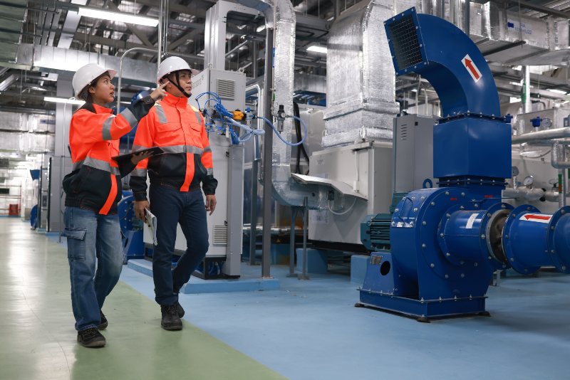 Facility team reviewing industrial safety measures on factory floor in Danville, VA.