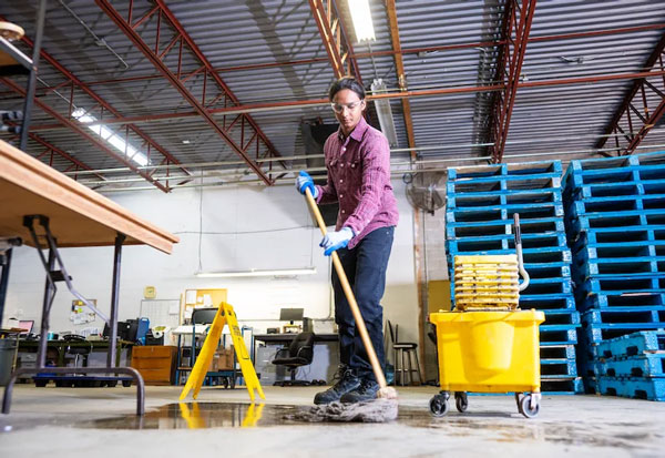 A man wiping a floor of an industrial estate in Danville, VA