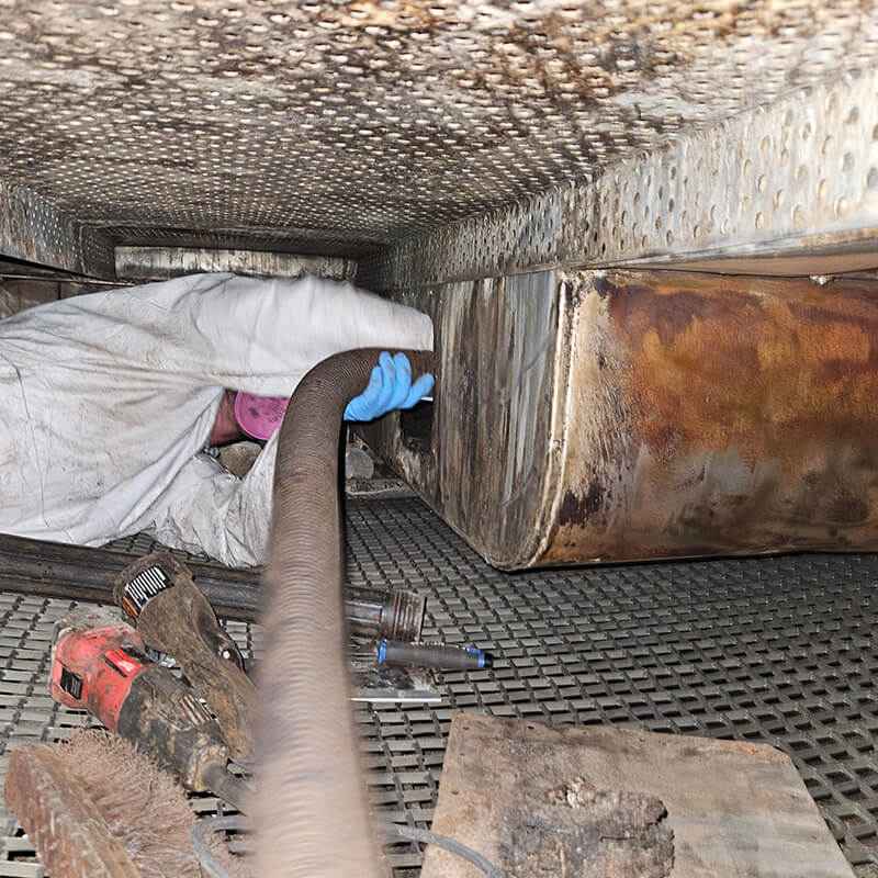 Worker in Suit Cleaning Crawlspace