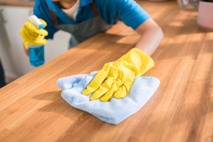 Professional deep cleaning technician sanitizing commercial facility surfaces