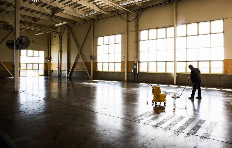 Industrial cleaning professional maintaining a commercial facility floor